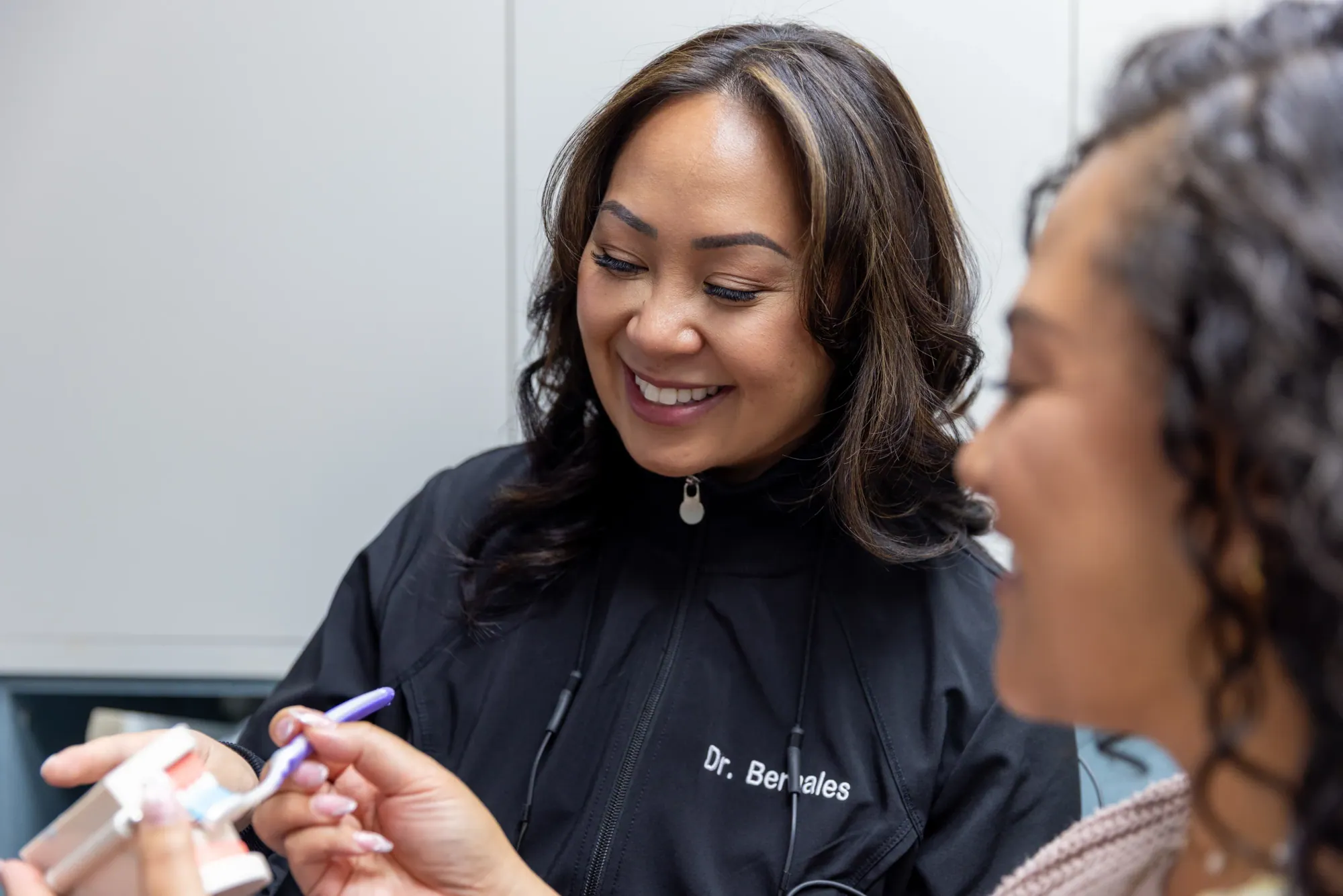 Dr. Bernales smiling as she talks a patient through her care